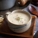 Clam chowder in a mug with crackers on the side